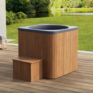 Cold Tub ICON with natural thermowood cladding and grey inner tub in an outdoor garden setting